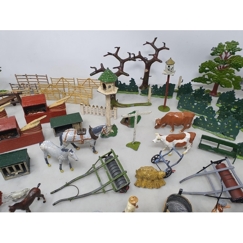 60 - An extensive Collection of painted alloy Farmyard Figures including horses, implements, fences, bell... 