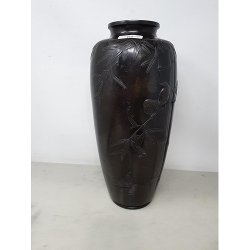 62 - A Japanese bronze Vase decorated birds amongst shrubs in low relief, 13in, signed