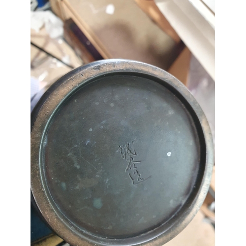 62 - A Japanese bronze Vase decorated birds amongst shrubs in low relief, 13in, signed