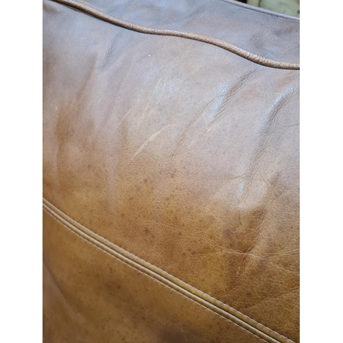 27 - A tan leather two seater Settee, raised on circular bun feet, 4ft 11