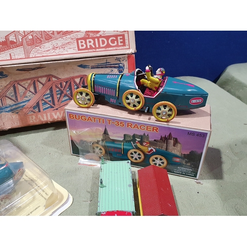 533 - A collection of tinplate and diecast Toys including a Mettoy Dolls House, two boxed Mettoy 0 gauge R... 