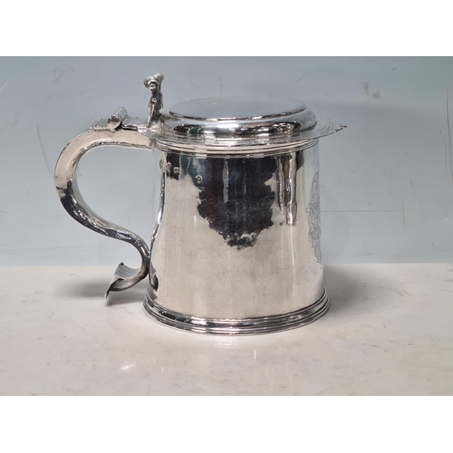 101 - A Charles II silver lidded Tankard with scroll thumb piece, flat section lid, engraved large armoria... 
