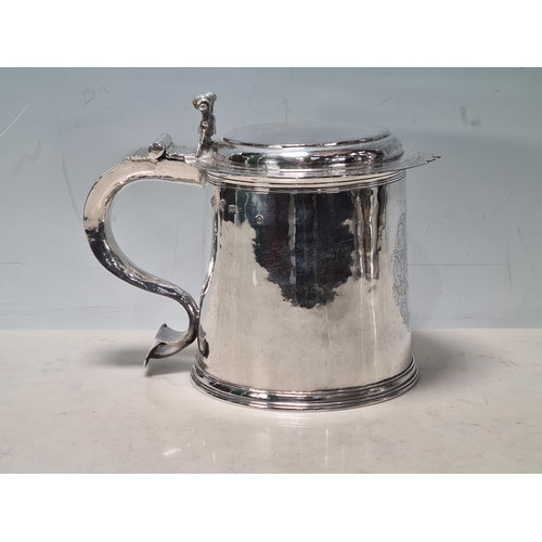 101 - A Charles II silver lidded Tankard with scroll thumb piece, flat section lid, engraved large armoria... 