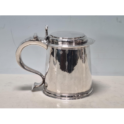 102 - A Charles 11 silver plain lidded Tankard with double scroll thumb piece, flat section lid, London 16... 