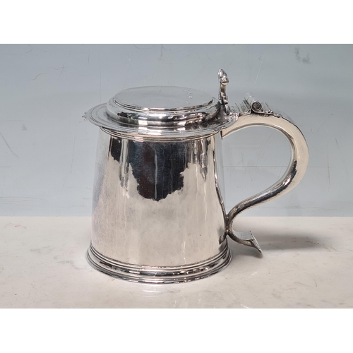 102 - A Charles 11 silver plain lidded Tankard with double scroll thumb piece, flat section lid, London 16... 