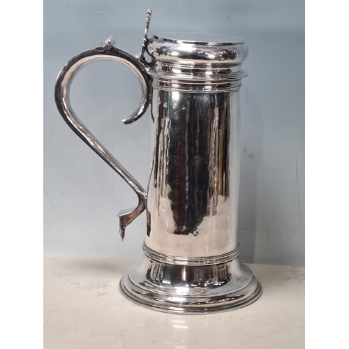 103 - A William & Mary large silver Flagon with pierced scroll thumb piece, flat lid, scroll handle, Londo... 