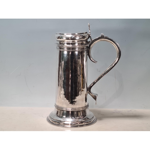 103 - A William & Mary large silver Flagon with pierced scroll thumb piece, flat lid, scroll handle, Londo... 