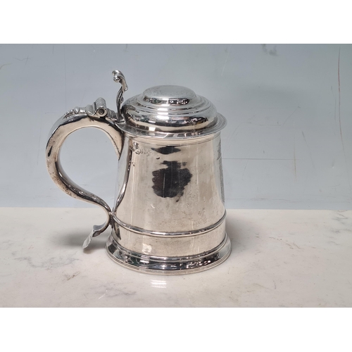 105 - A George II silver lidded Tankard with scroll thumb piece, engraved shield shape coat of arms surmou... 