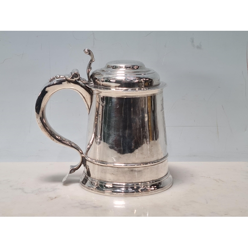 105 - A George II silver lidded Tankard with scroll thumb piece, engraved shield shape coat of arms surmou... 
