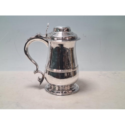 108 - A George III silver lidded baluster Tankard with pierced thumb piece, domed lid scroll handle engrav... 