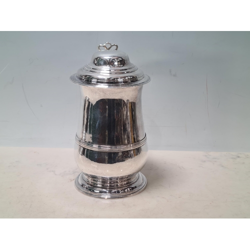 108 - A George III silver lidded baluster Tankard with pierced thumb piece, domed lid scroll handle engrav... 