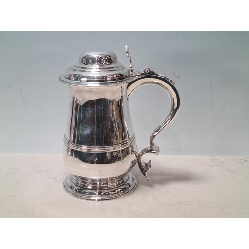 108 - A George III silver lidded baluster Tankard with pierced thumb piece, domed lid scroll handle engrav... 