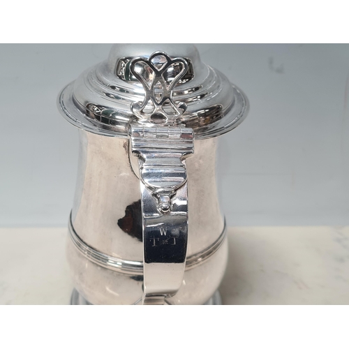 108 - A George III silver lidded baluster Tankard with pierced thumb piece, domed lid scroll handle engrav... 