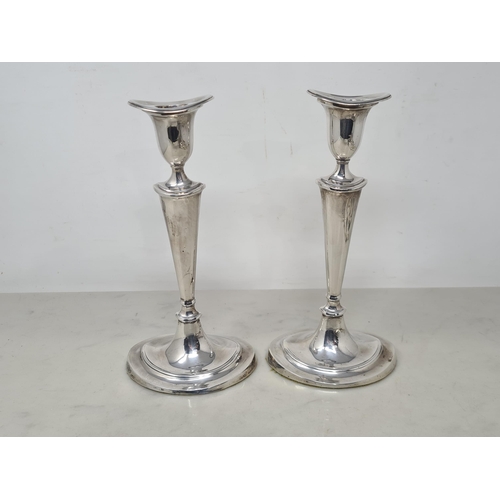 112 - A pair of George V silver Candlesticks with tapering columns on oval bases, Sheffield 1918