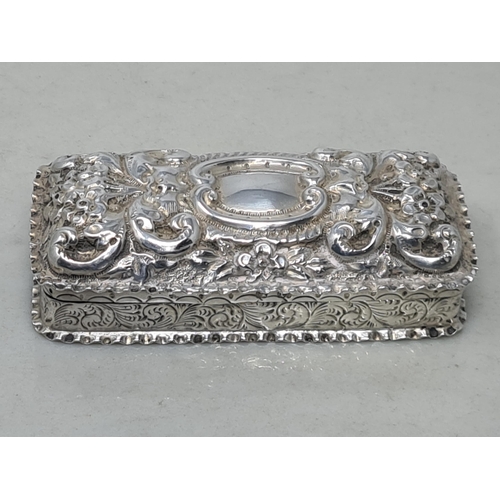 69 - A Victorian silver rectangular Box with floral and scroll embossing, vacant cartouche, Birmingham 18... 