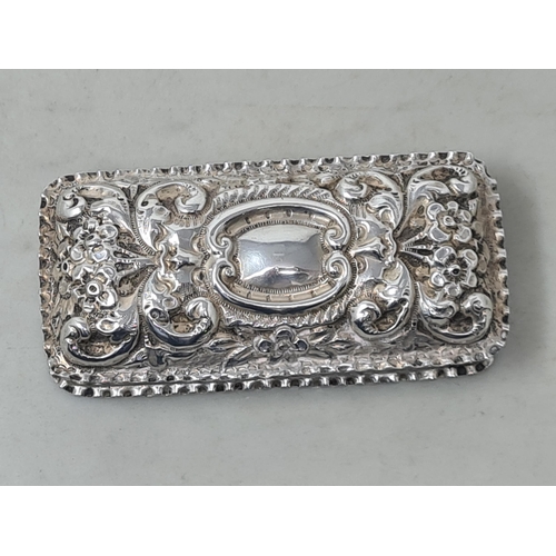 69 - A Victorian silver rectangular Box with floral and scroll embossing, vacant cartouche, Birmingham 18... 