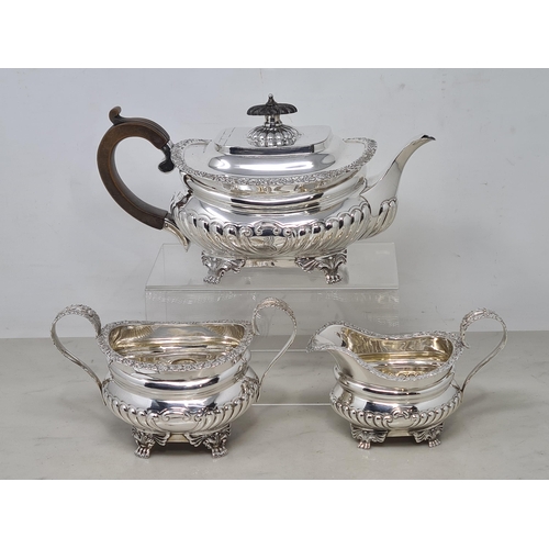 75 - An Edward VII silver three piece Tea Service of boat shape with gadroon embossing, floral border, en... 