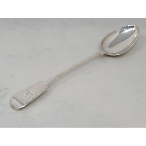 84 - A Victorian silver Basting Spoon fiddle pattern engraved crest, London 1856, 150gms