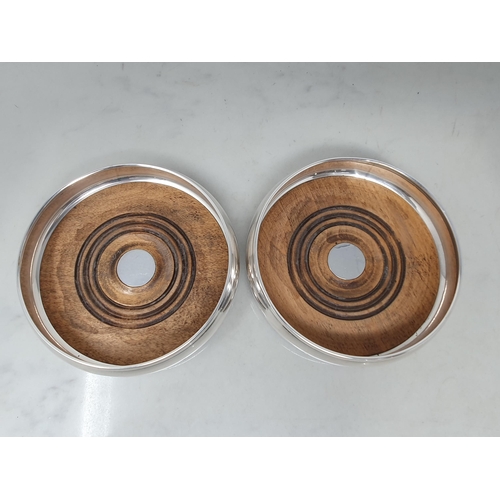 87 - A pair of modern silver circular Coasters with turned wooden bases, London 1991