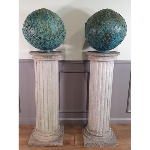 A pair of large fluted reconstituted circular Columns on square bases ...