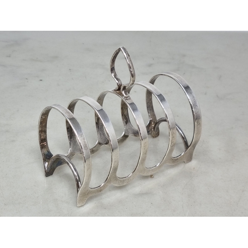 122 - A George V silver five bar Toastrack, Birmingham 1931, 80gms, two silver Napkin Rings ,another plate... 