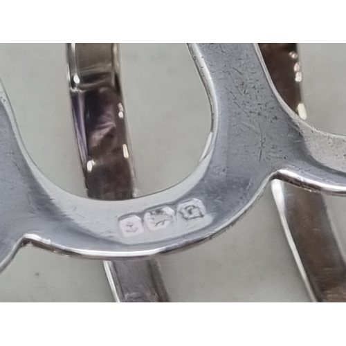 122 - A George V silver five bar Toastrack, Birmingham 1931, 80gms, two silver Napkin Rings ,another plate... 