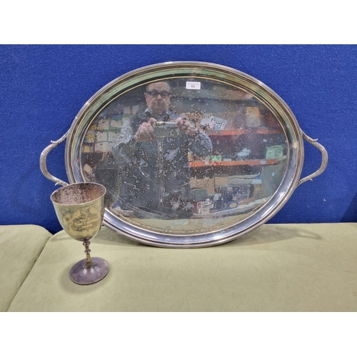 65 - A plated oval two handled Tea Tray, 28in and a plated Sporting Trophy
