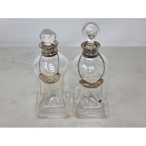 87 - A pair of George V silver mounted glass Spirit Flasks, Birmingham 1912, two silver Whisky Labels, a ... 