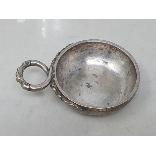 97 - A Continental white metal circular Wine Taster with serpent handle, and a plated Wine Jug with domed... 