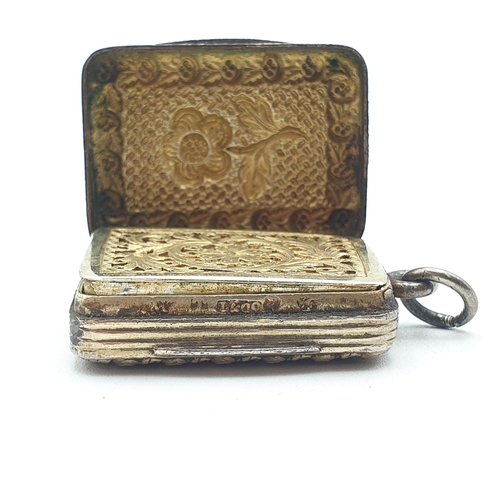 247 - A silver and silver-gilt Vinaigrette with repoussé decoration to front and back and engraved cut-out... 