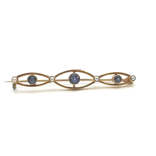 254 - An early 20th Century Sapphire and Seed Pearl Bar Brooch, stamped 15ct, approx 4.5cm wide, approx 3.... 