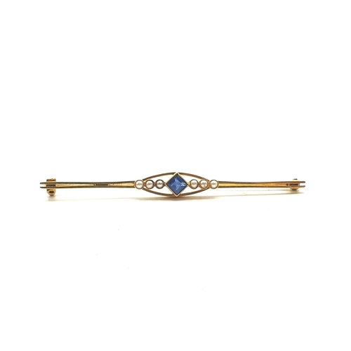 255 - An Edwardian Bar Brooch set step-cut sapphire between trios of seed pearls, marked 15ct, approx 6.5c... 