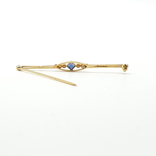 255 - An Edwardian Bar Brooch set step-cut sapphire between trios of seed pearls, marked 15ct, approx 6.5c... 
