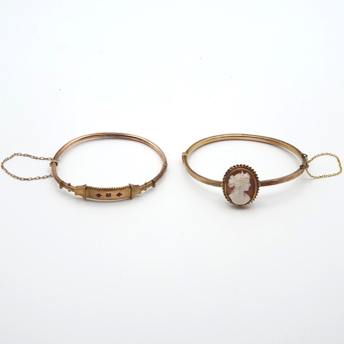 265 - A 9ct gold hinged  Bangle the front single diamond between two round rubies, approx 6gms and a hinge... 