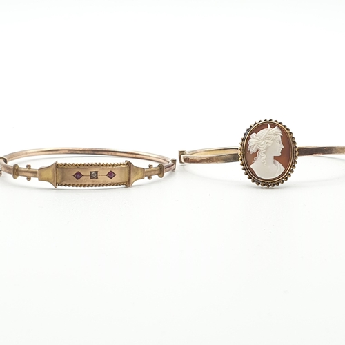 265 - A 9ct gold hinged  Bangle the front single diamond between two round rubies, approx 6gms and a hinge... 