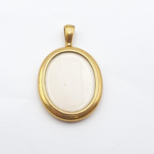 270 - A double-sided Locket stamped 9ct, 52mm long, glazed panels front and back, approx 12.1gms