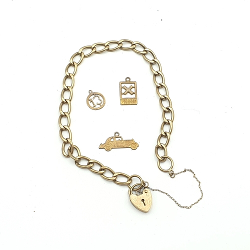 279 - A 9ct gold curb link Bracelet with padlock fastener and three charms, approx 6.8gms