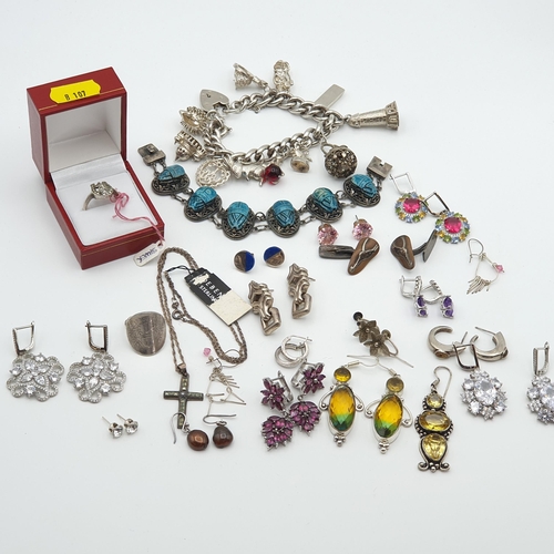 287 - A silver curb link Bracelet with numerous charms, a scarab type Bracelet and a collection of mostly ... 