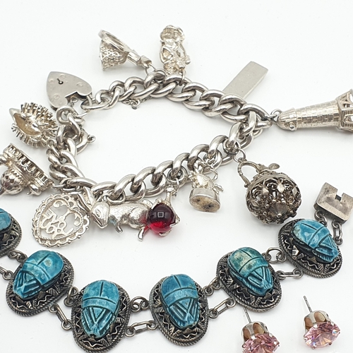 287 - A silver curb link Bracelet with numerous charms, a scarab type Bracelet and a collection of mostly ... 