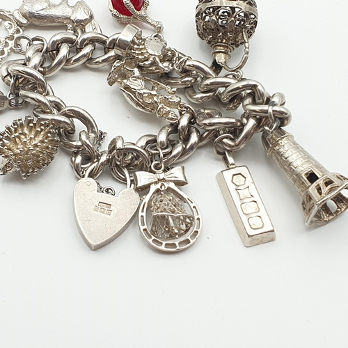 287 - A silver curb link Bracelet with numerous charms, a scarab type Bracelet and a collection of mostly ... 