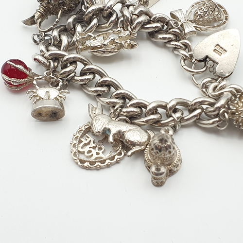 287 - A silver curb link Bracelet with numerous charms, a scarab type Bracelet and a collection of mostly ... 