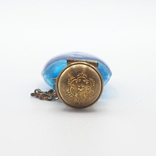 292 - A blue glass Scent Bottle with fruiting vine enamel decoration and gilt metal lid, 2 1/2 inches