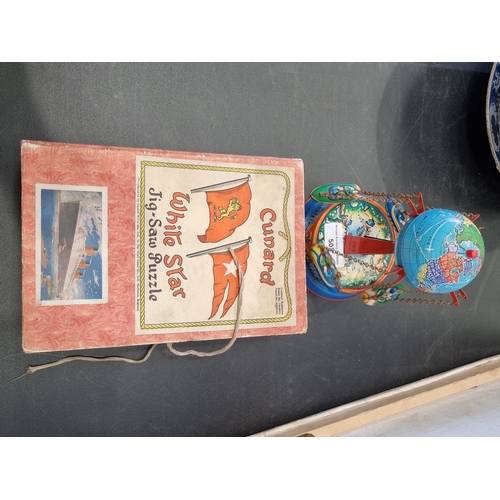 503 - A Cunard White Star Jig-Saw Puzzle, boxed and a German tin-plate globe Roundabout (R5)