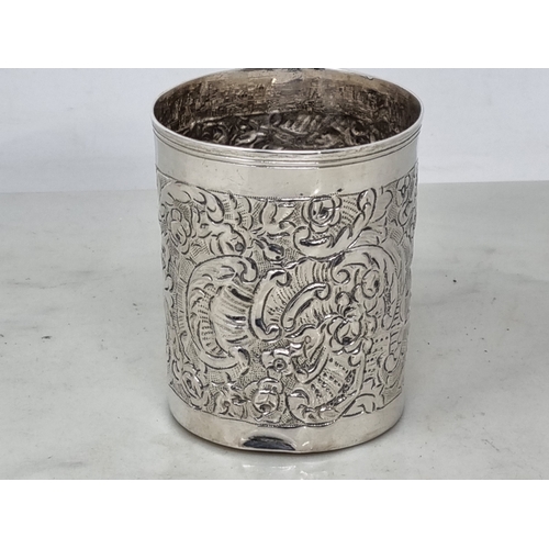 55 - A Continental silver Beaker with floral and scroll embossing, 3in, 80gms