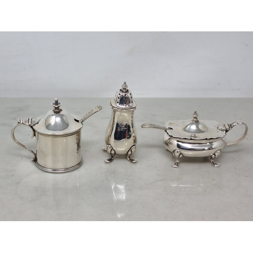63 - Two silver Mustard Pots, a Pepperette and two plated Spoons, 110gms