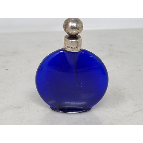 64 - An Elizabeth II silver mounted Bristol blue glass Scent Bottle, London 1987, and four clear glass Sc... 