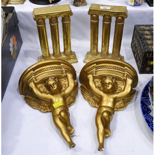 385 - Four gold coloured ornaments including a pair of cherub wall brackets and a pair of columns