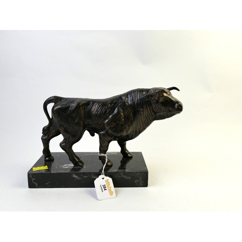 384 - A bronze effect bull figure, mounted on a marble plinth