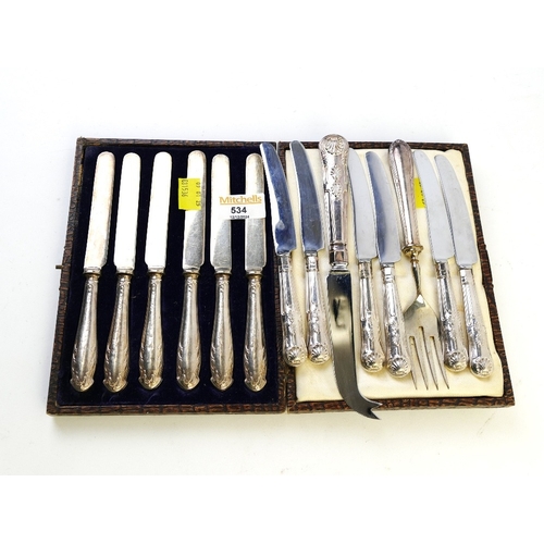 534 - Cased set of six silver handled butter knives with stainless steel blades and another eight pieces o... 