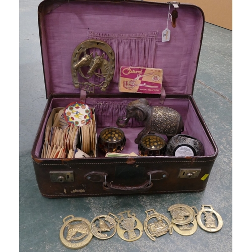 87 - Vintage suitcase containing beer mats, horse brasses, candleholders etc